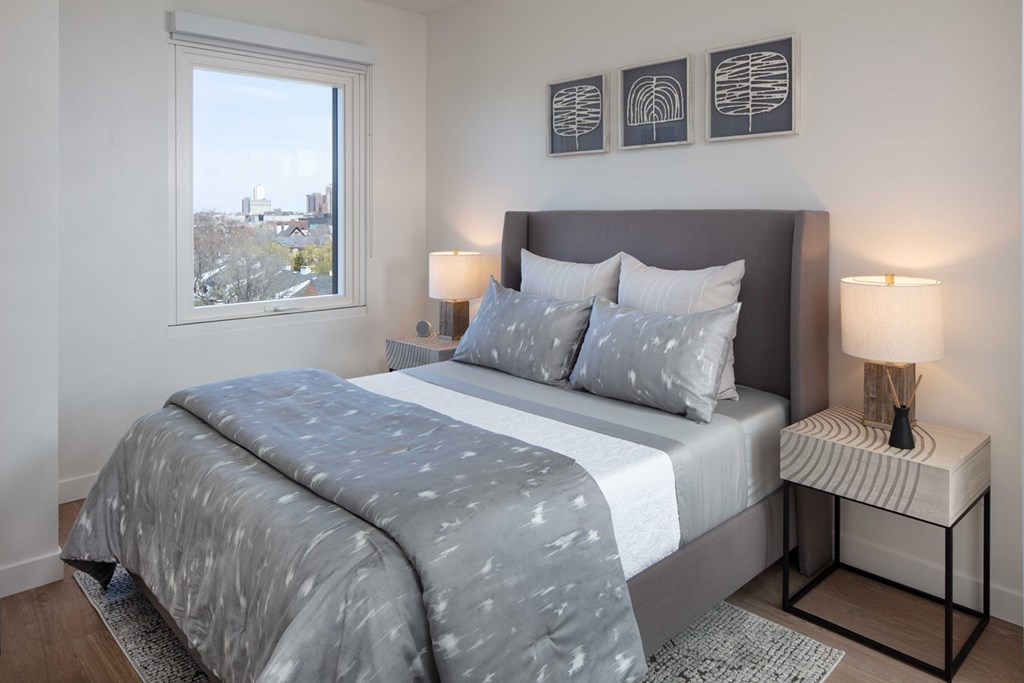 a bedroom with a large bed and a window