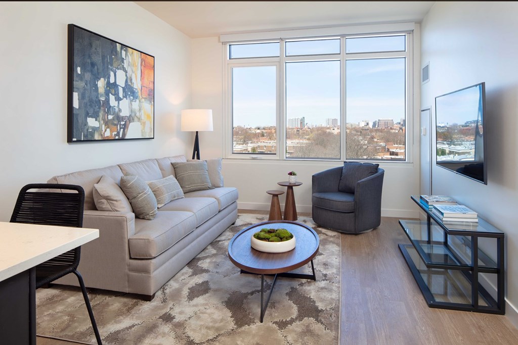 Luxury Apartments In Chicago, IL For Rent - North + Vine - Living Room With Luxury, Wood-Style Flooring, High-Ceilings, And Oversized Windows With Stunning Views.