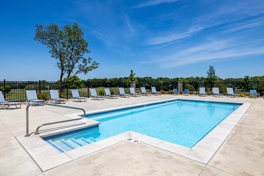 Fairway Flats - Pool Area with Lounge Chairs and Views of Lush Greenery