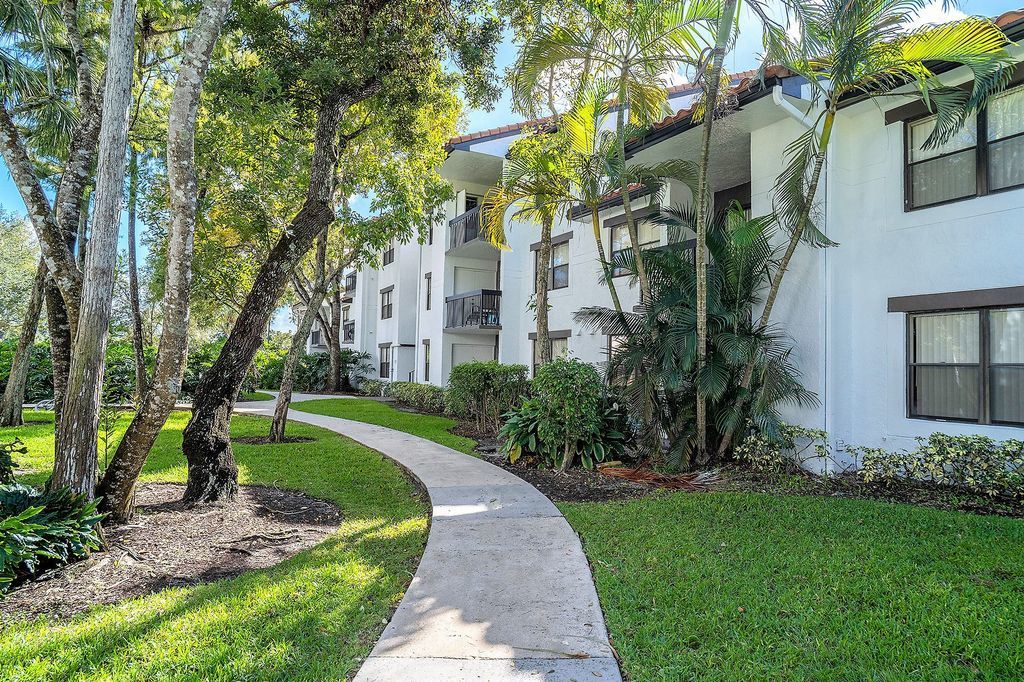 Exterior view of three-story apartment with sidewalk