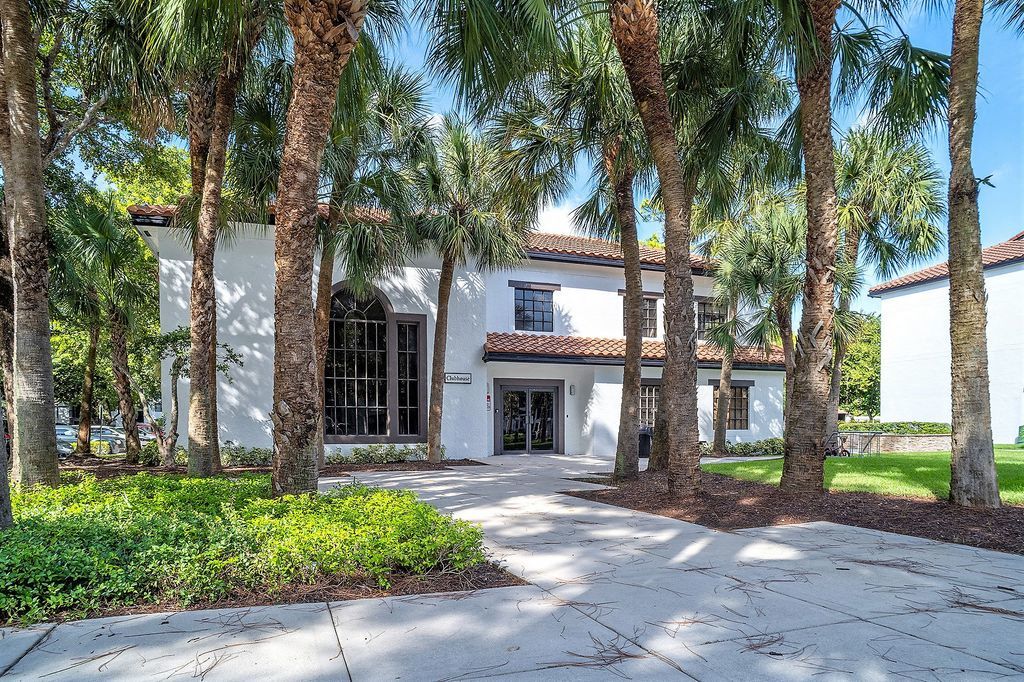 Exterior view of leasing office behind palm trees