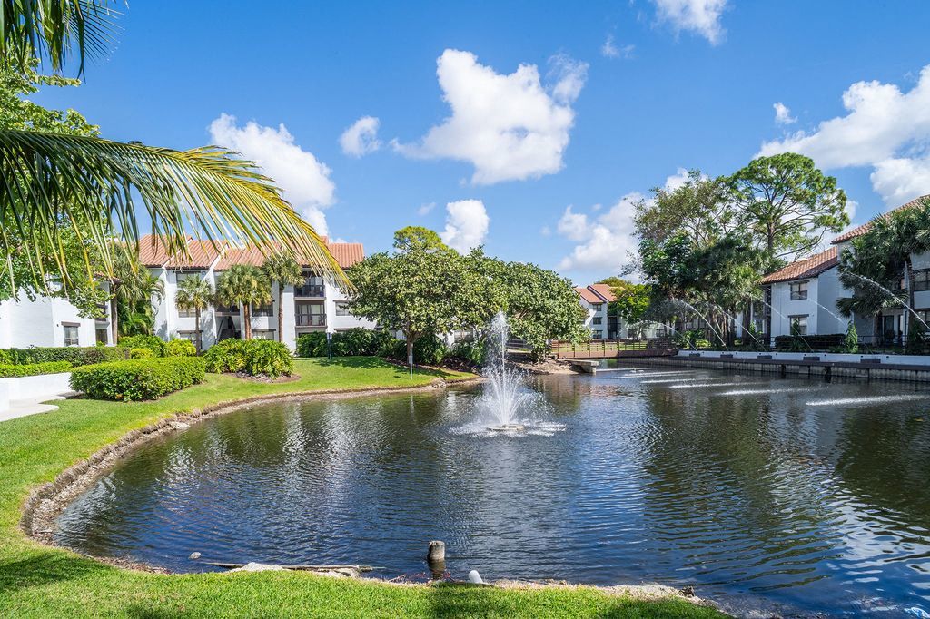 Lake with fountain with apartment building in background