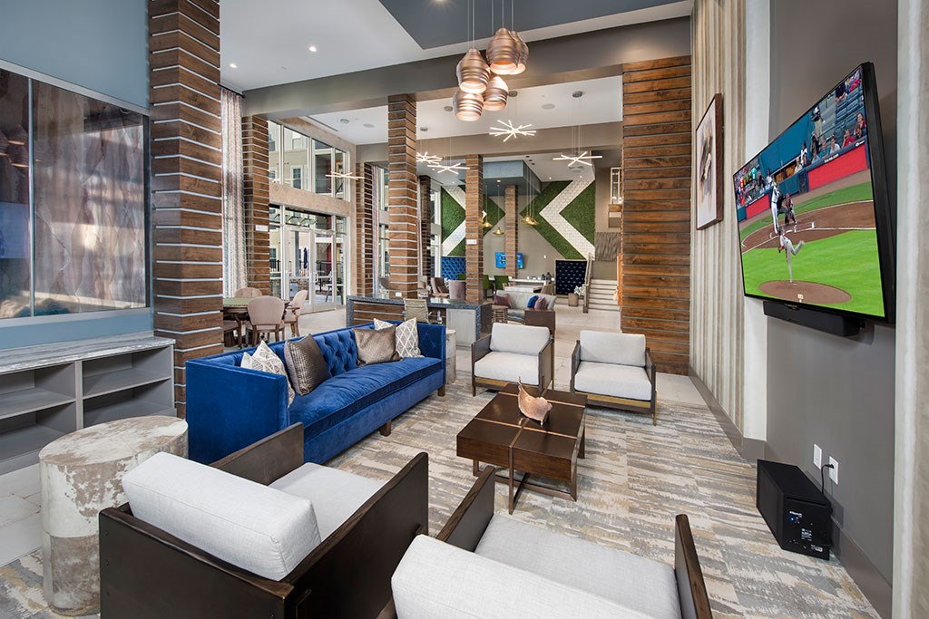 a living room with a blue couch and a tv