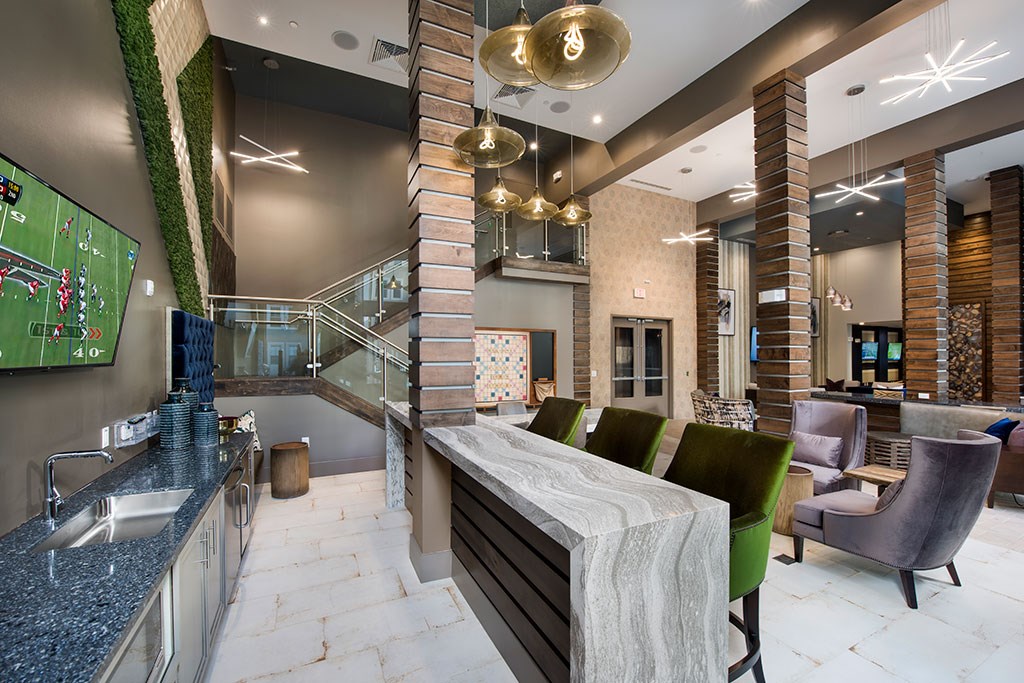 a large lobby with a bar and a tv