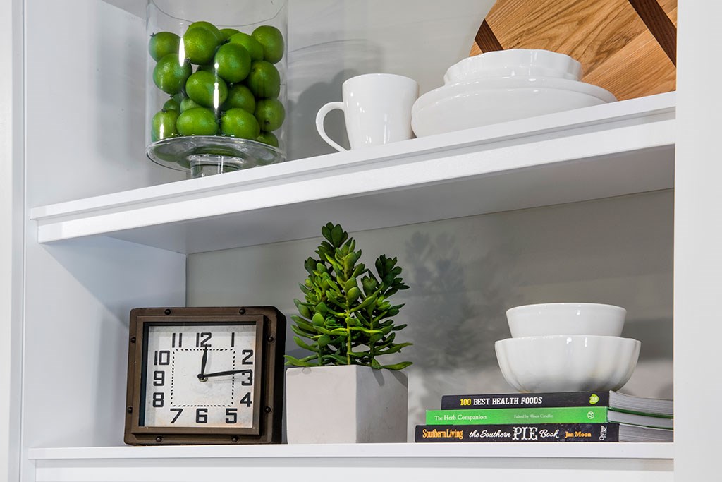 a shelf with a clock and books on it