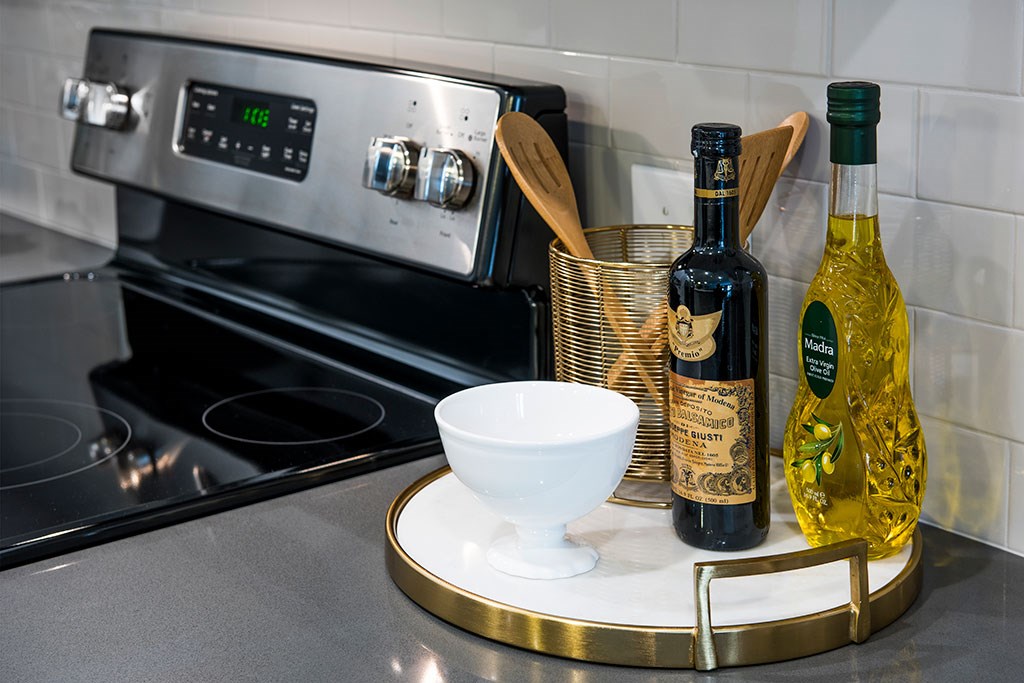 a kitchen counter with a bowl and bottles of wine on it