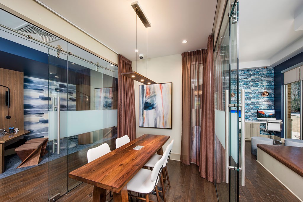 a dining room with a wooden table and white chairs