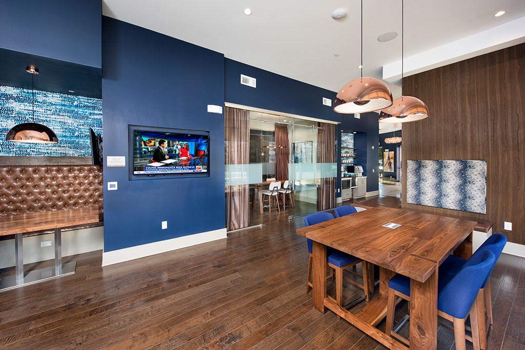 a dining room with blue walls and a wooden table