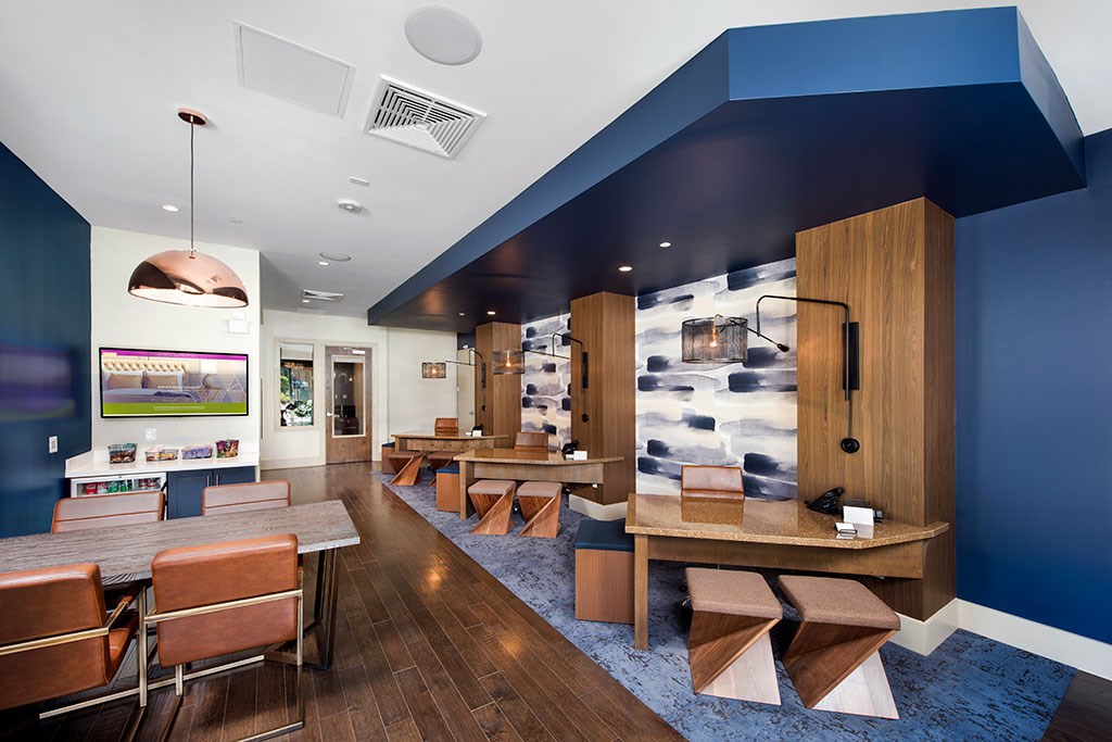 a restaurant with wooden tables and chairs and a blue and white wall