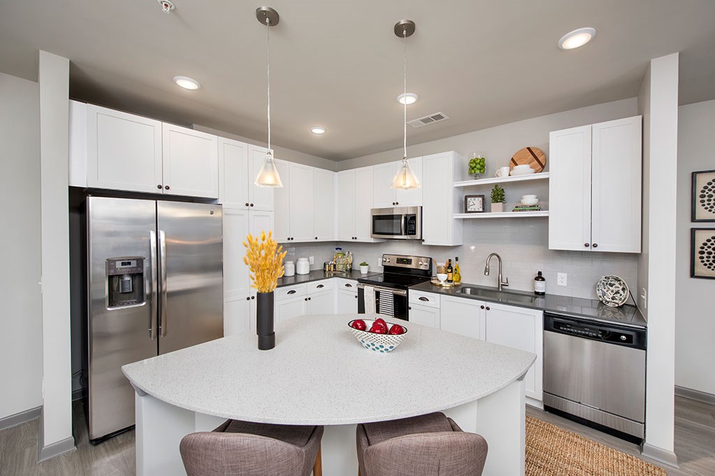 a kitchen with stainless steel appliances and a white counter top