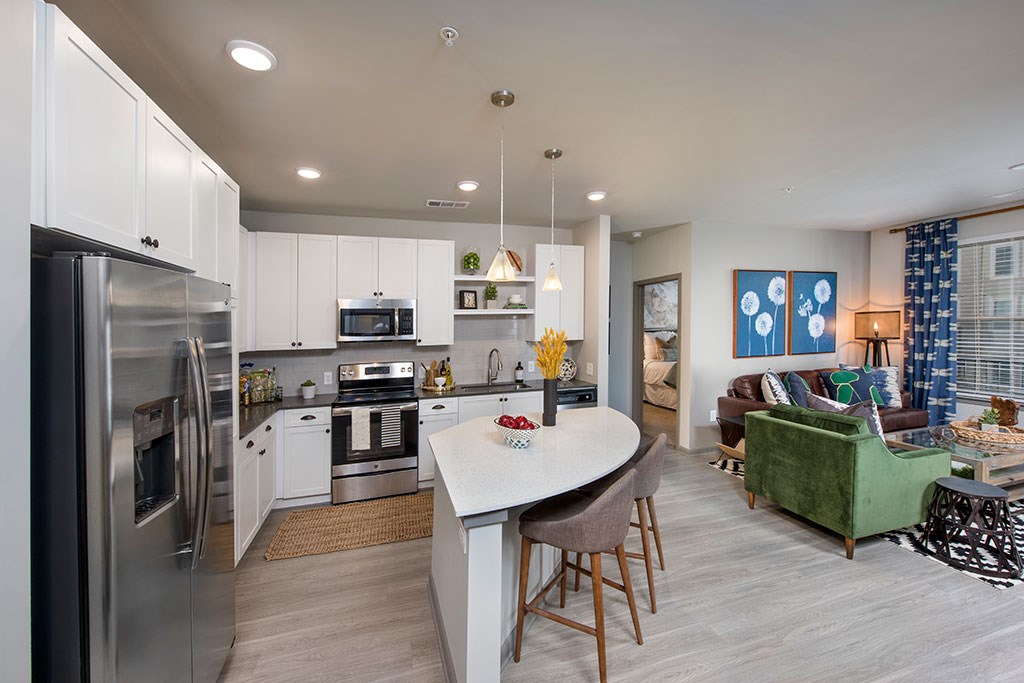 a kitchen with stainless steel appliances and a table
