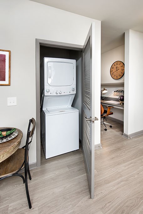 a white washer and dryer in a room next to a door