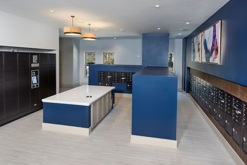 a blue and white lobby with a white counter and blue walls