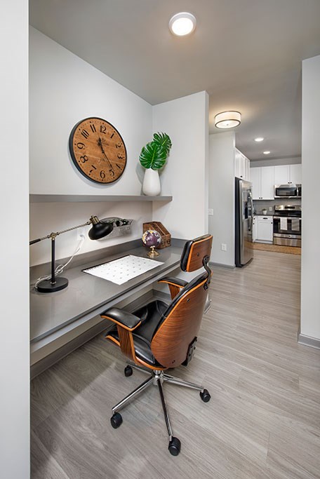 a room with a desk and a clock on the wall