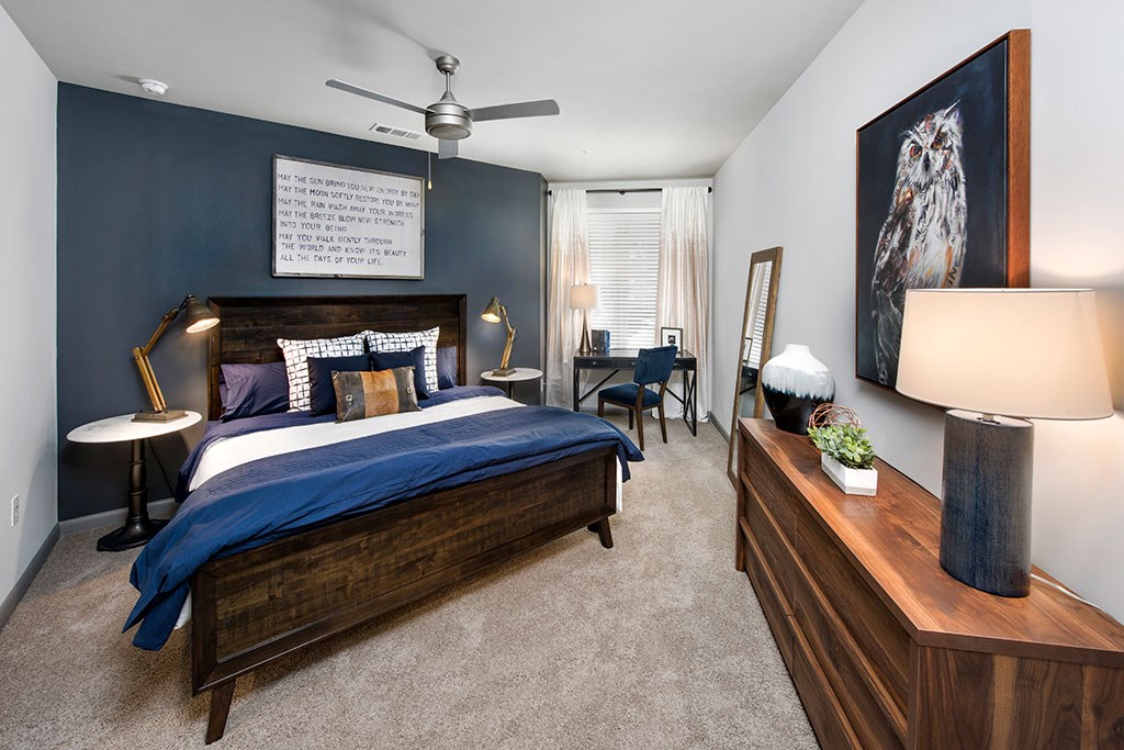 a bedroom with a bed and a ceiling fan