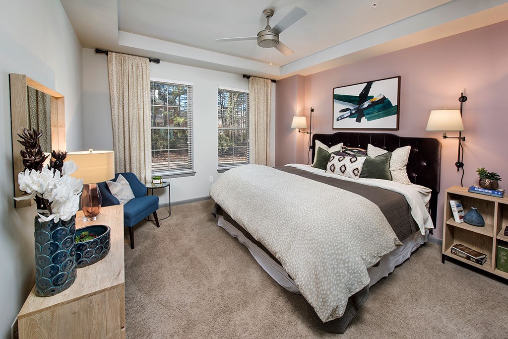 a bedroom with pink walls and a bed with pillows