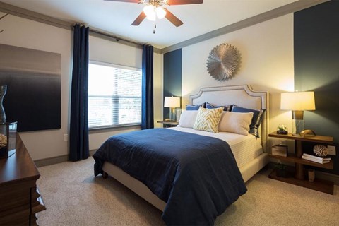 a bedroom with a bed and a ceiling fan