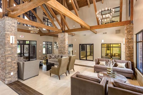 a large living room with couches and chairs and a chandelier
