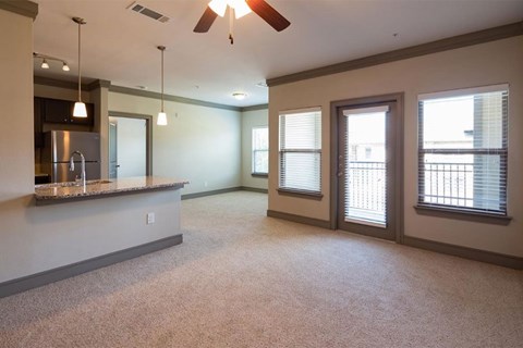 a living room and a kitchen with a counter top