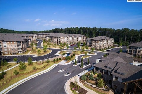 an aerial view of an apartment complex with roads and buildings