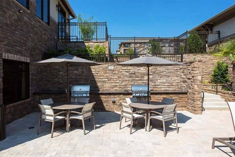 a patio with tables and umbrellas