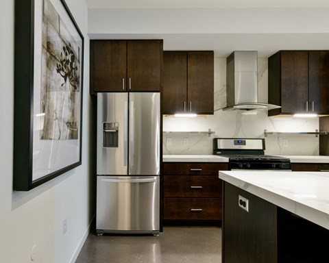 a kitchen with a stainless steel refrigerator