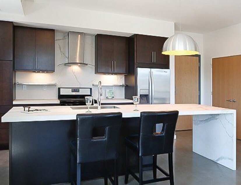 Kitchen of 16Twenty with white marble countertops, Stainless Vent hood and appliances