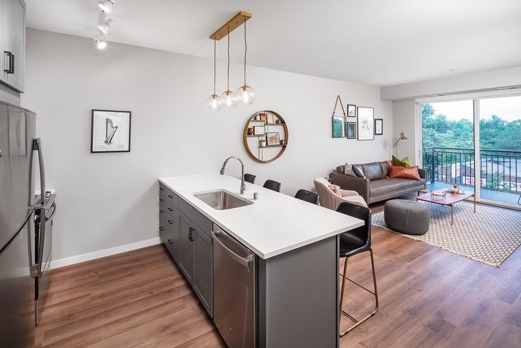 Kitchen island with wood flooring  at Harper Apartments in St Paul, MN