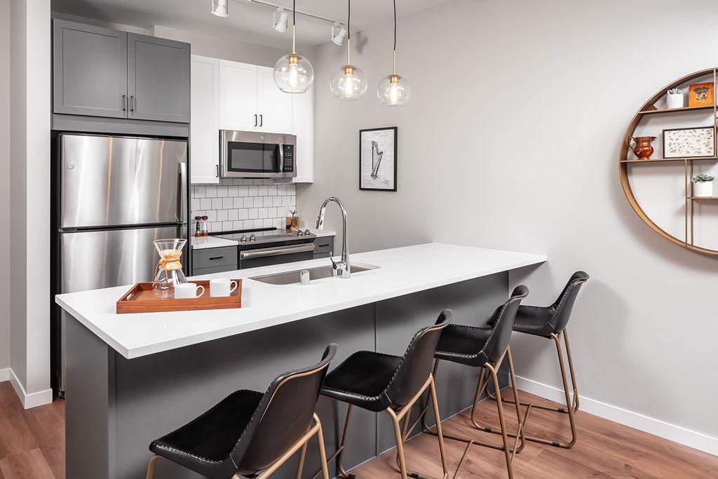 Modern kitchen with granite countertops at The Harper