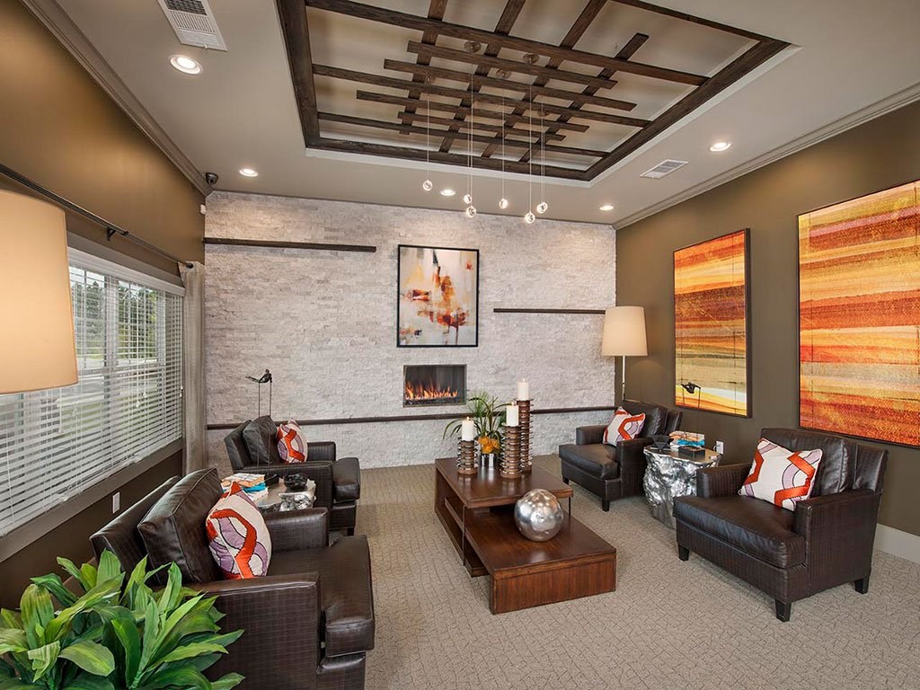 a living room with couches and chairs and a fireplace