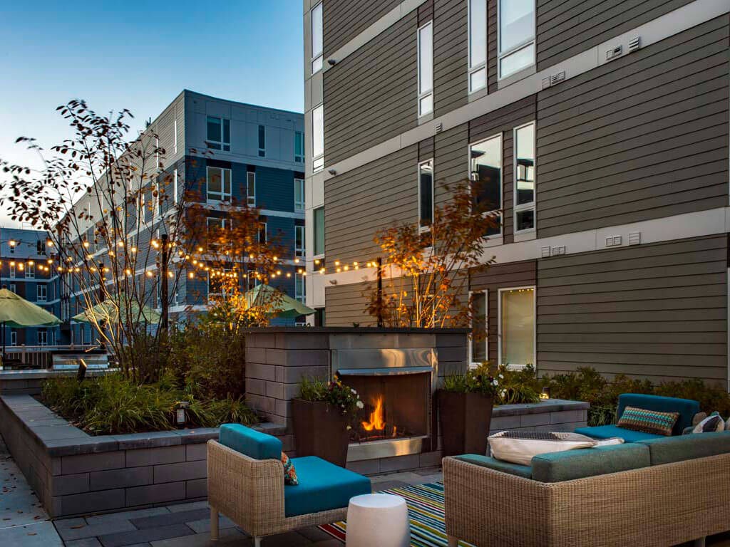 Outdoor lounge with fireplace and soft seating
