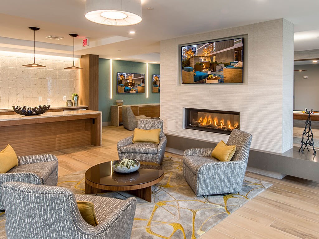 Club room with soft seating and fireplace