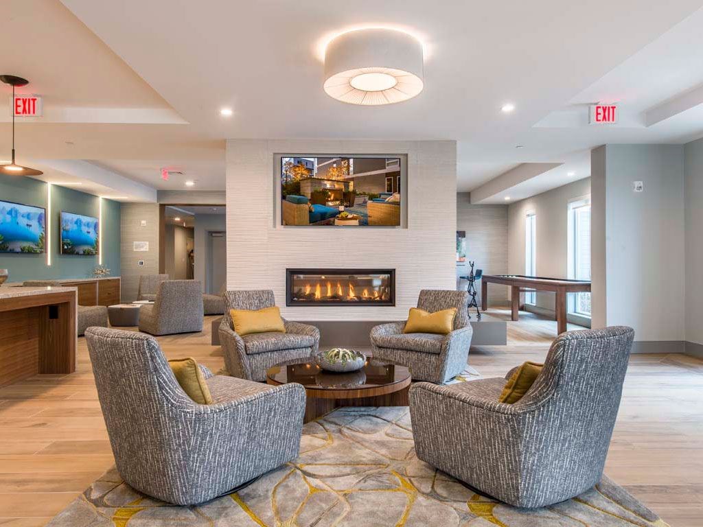 Four chairs around coffee table with fireplace in background
