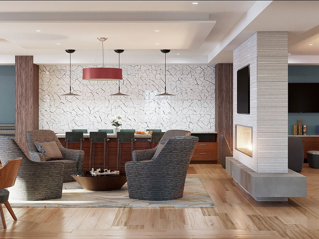 Amenity space with soft seating, tables and fireplace