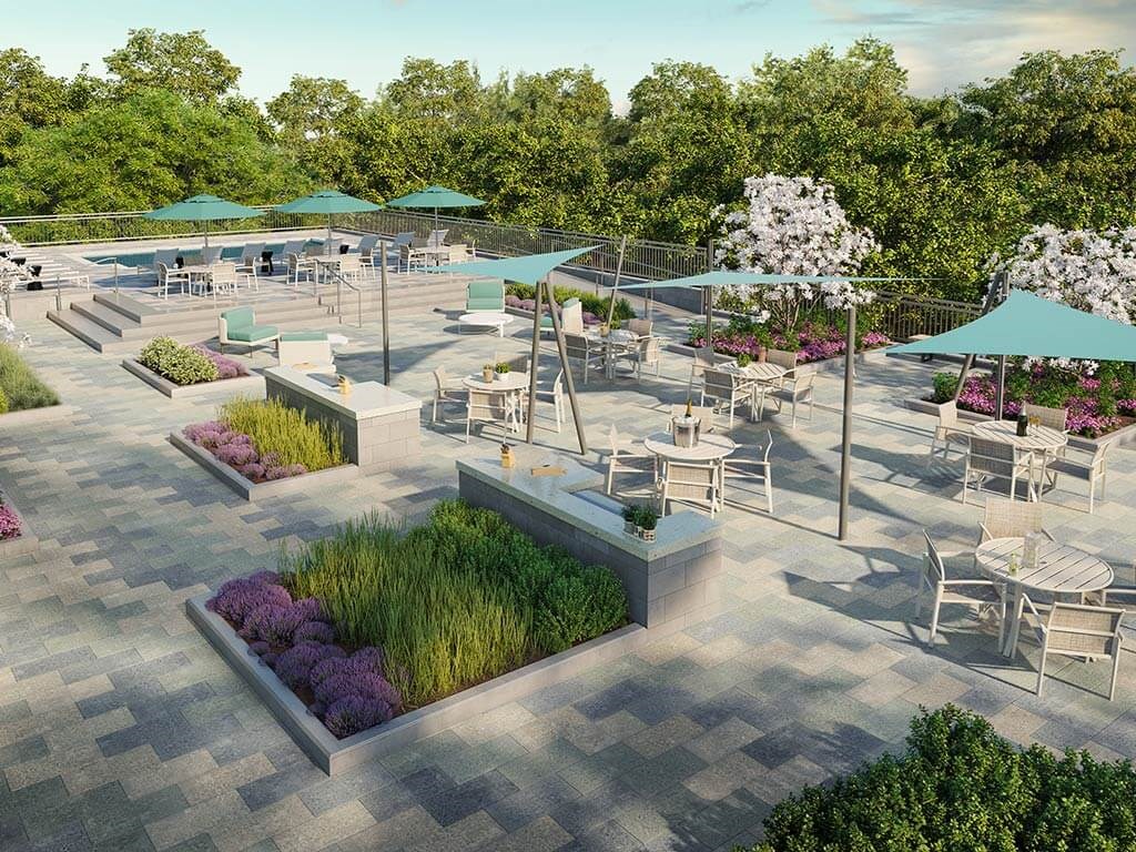 Elevated view of sun deck with variety of tables, chairs and sun shades