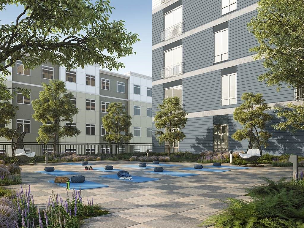 Yoga courtyard with building in background and trees