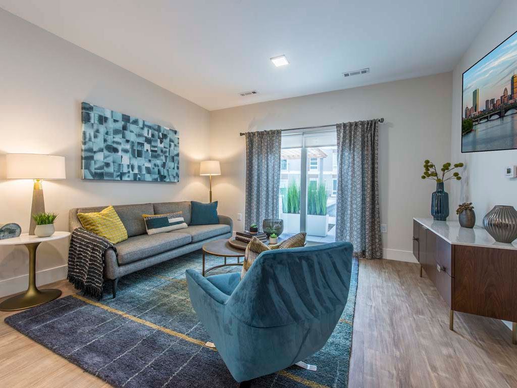 View of living room towards windows with couch and chair