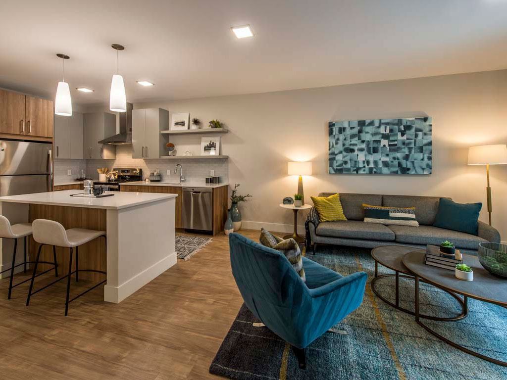 Partial view of model apartment kitchen and living room