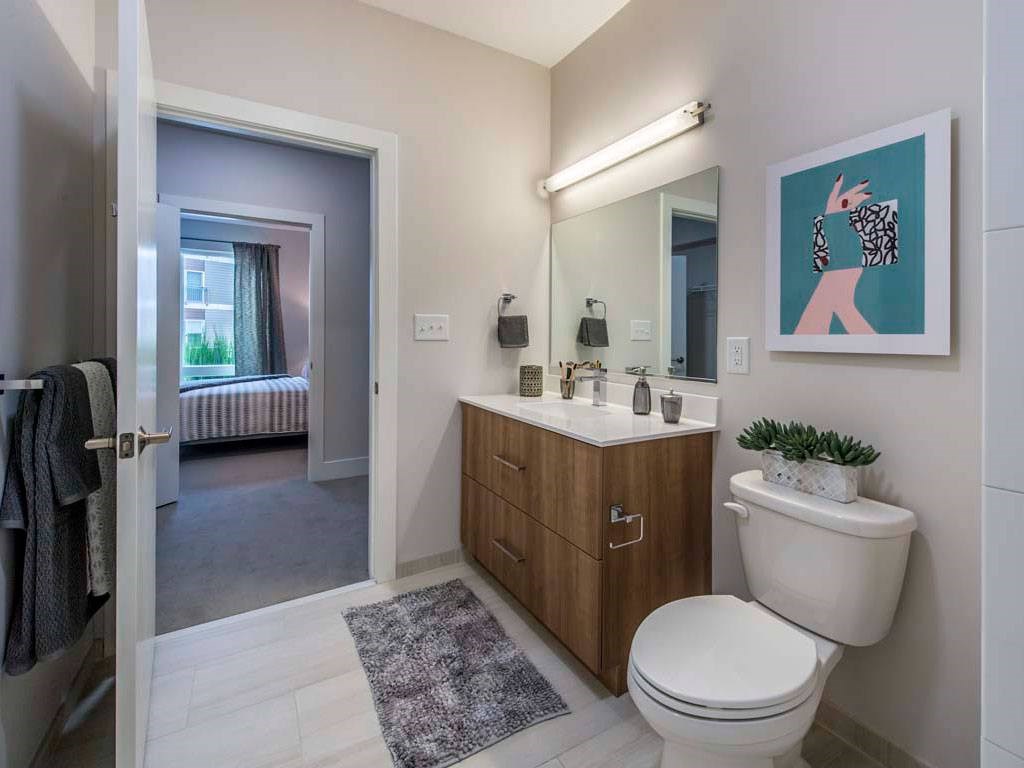 View from inside bathroom showing toilet and vanity towards bedroom