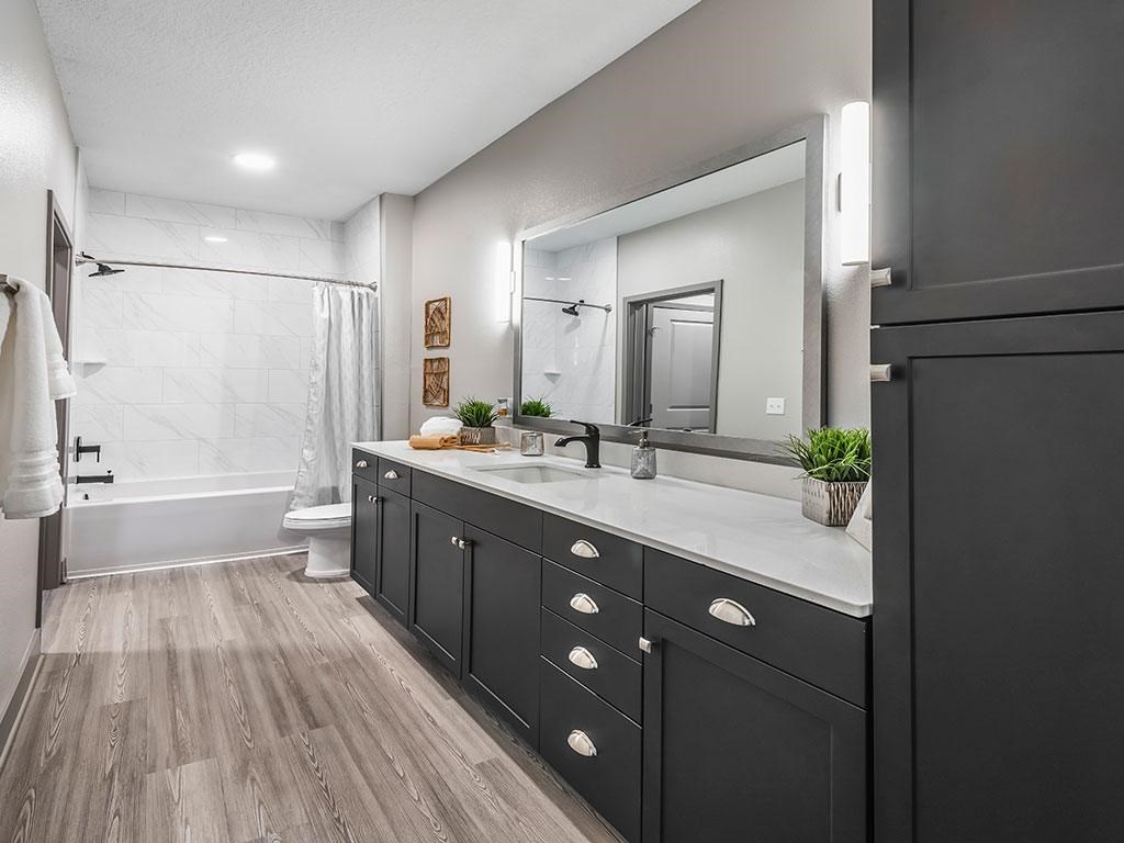 the westerly apartments orlando florida bathroom with an overabundance of cabinets and tub and shower combo