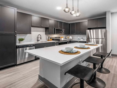 a kitchen with stainless steel appliances and a white counter top