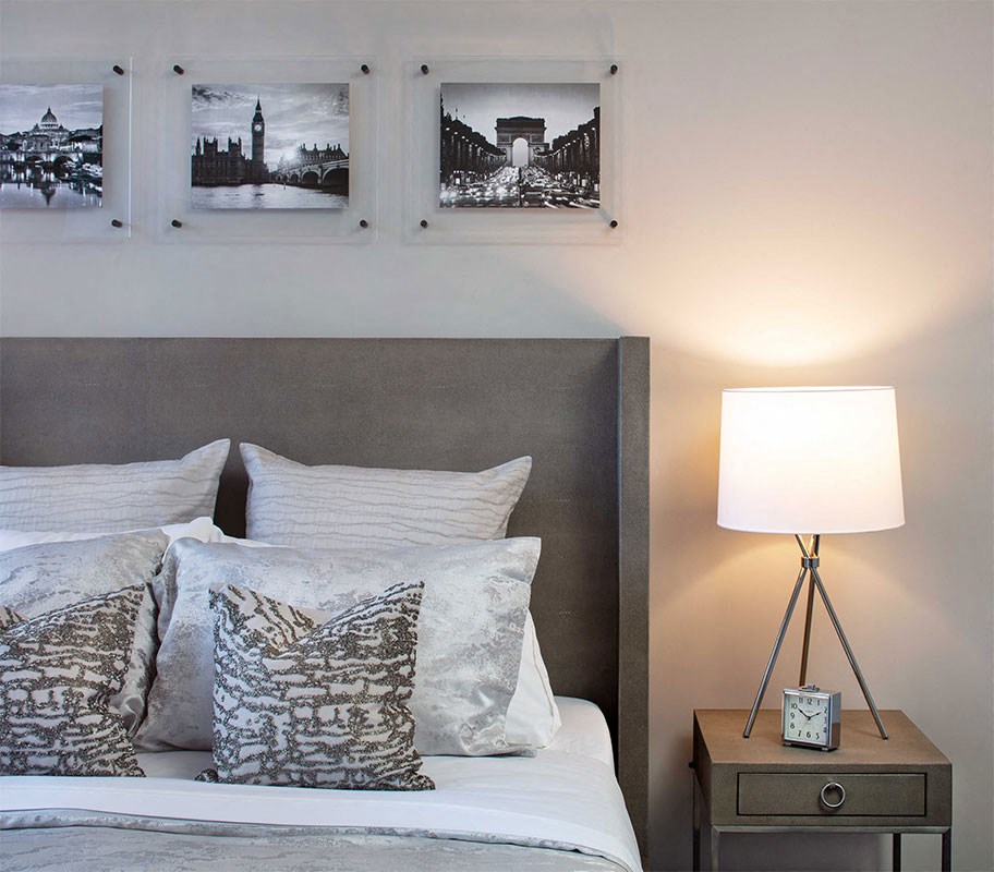 a bedroom with a bed and pictures on the wall
