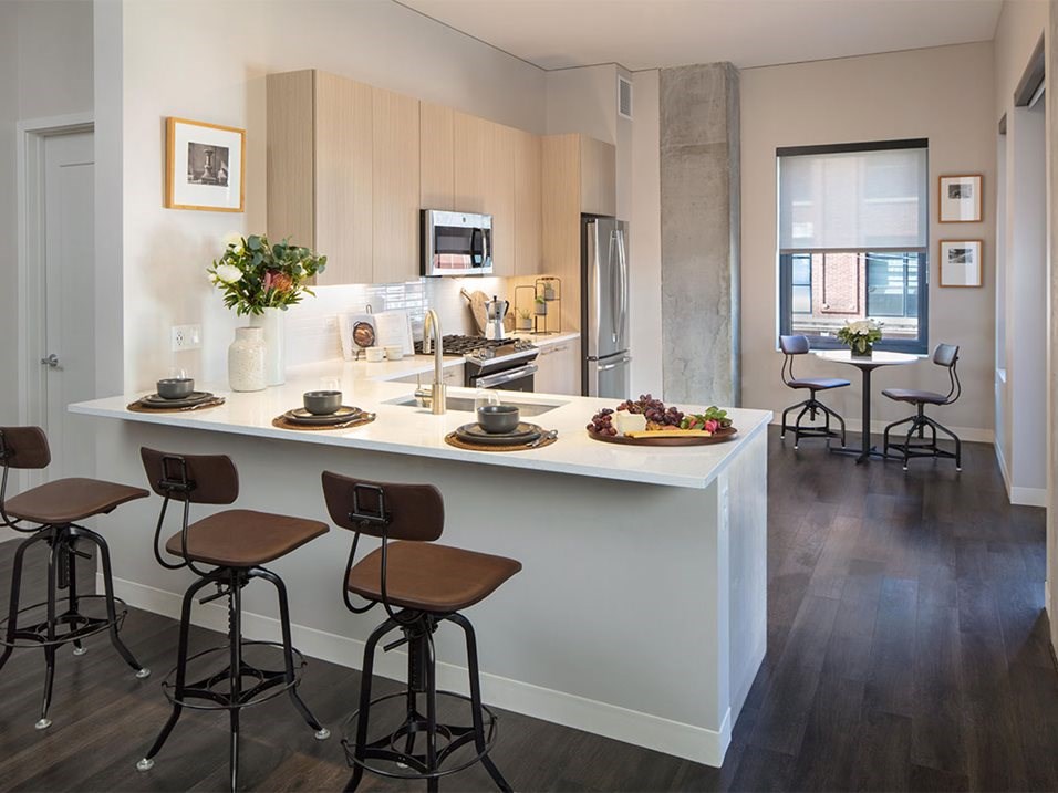 a kitchen with a counter and stools