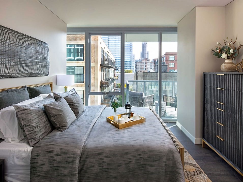 a bedroom with a bed and a large window