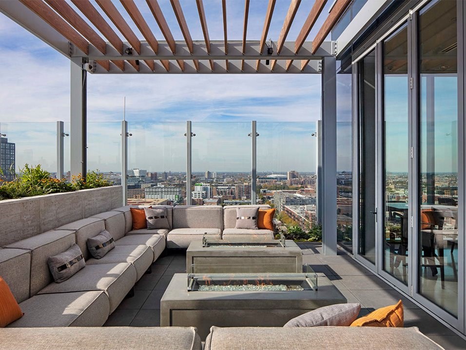 a living room with couches and a table overlooking a city