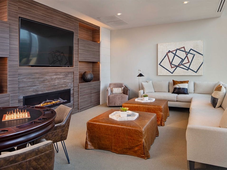 a living room with a television and a table with chairs