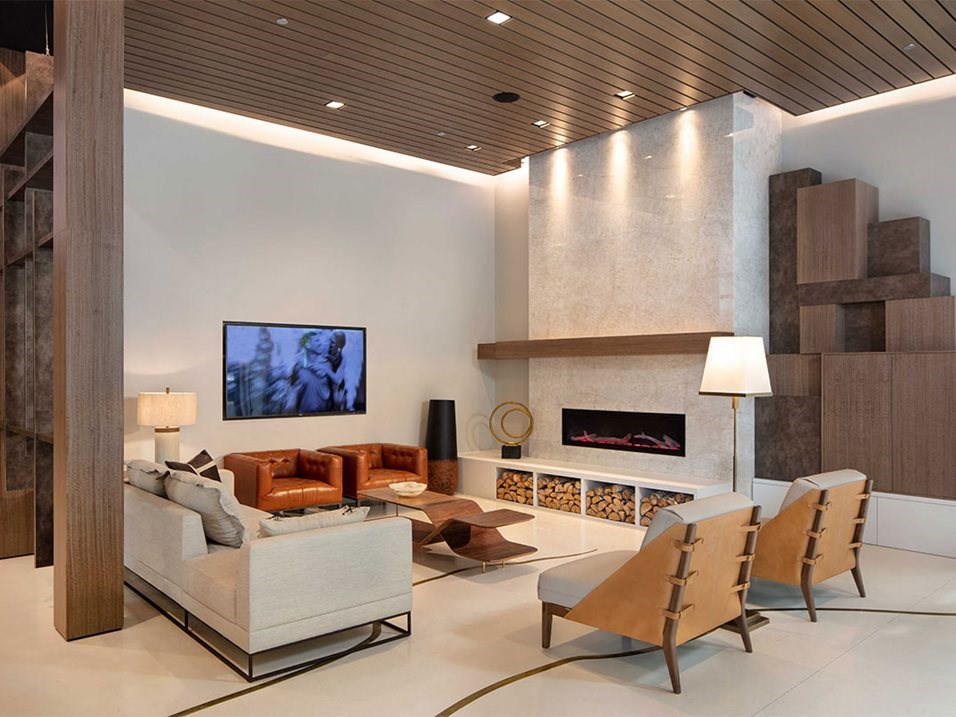 a living room with a couch and chairs and a fireplace