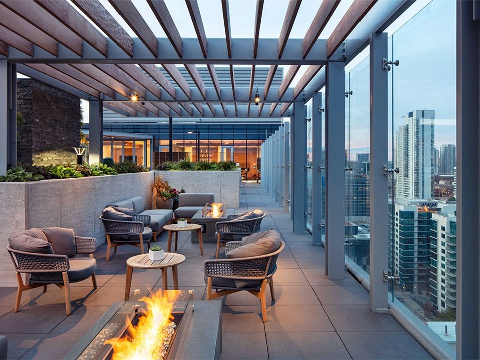 a rendering of the rooftop terrace with chairs and a fire pit