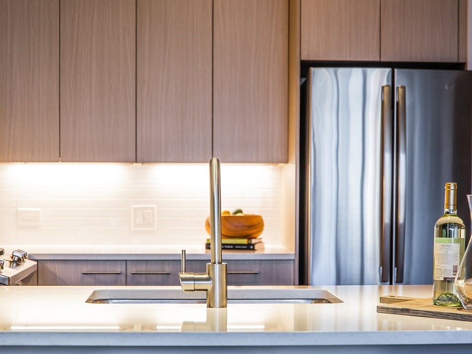 a kitchen with a sink and a refrigerator