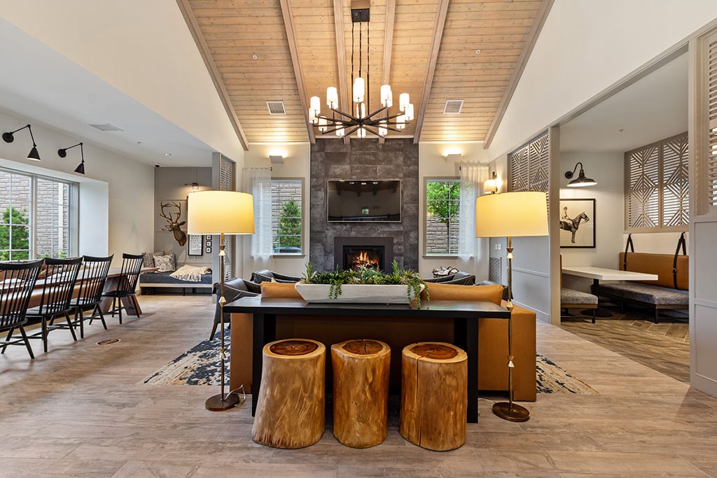 Resident lounge with soft seating, workspaces and fireplace